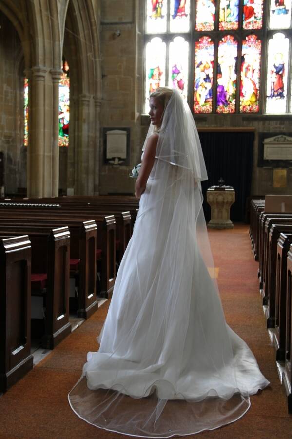 photographer dslrphotomart uncategorized modelling photo taken at Westbury Church with  Victoria Summers. bride in the aisle with back lighting from the stained glass window.