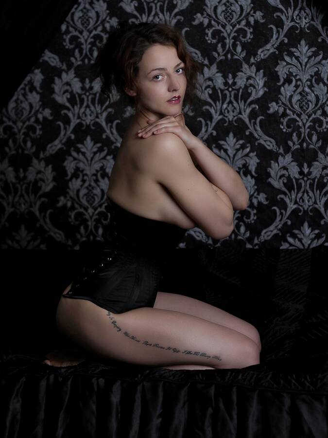 model Miss Lilu theme modelling photo. caught in a moment of self sabotage bone corset smooth soft silky.