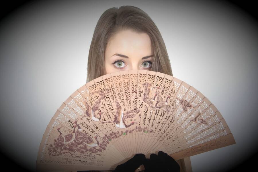 photographer waist it headshot modelling photo taken at My Havant Studio with  Josie_Lauren. dancer and model josie lauren tries to hide her identity behind a handcarved chinese fan only her beautiful big green eyes give her away.
