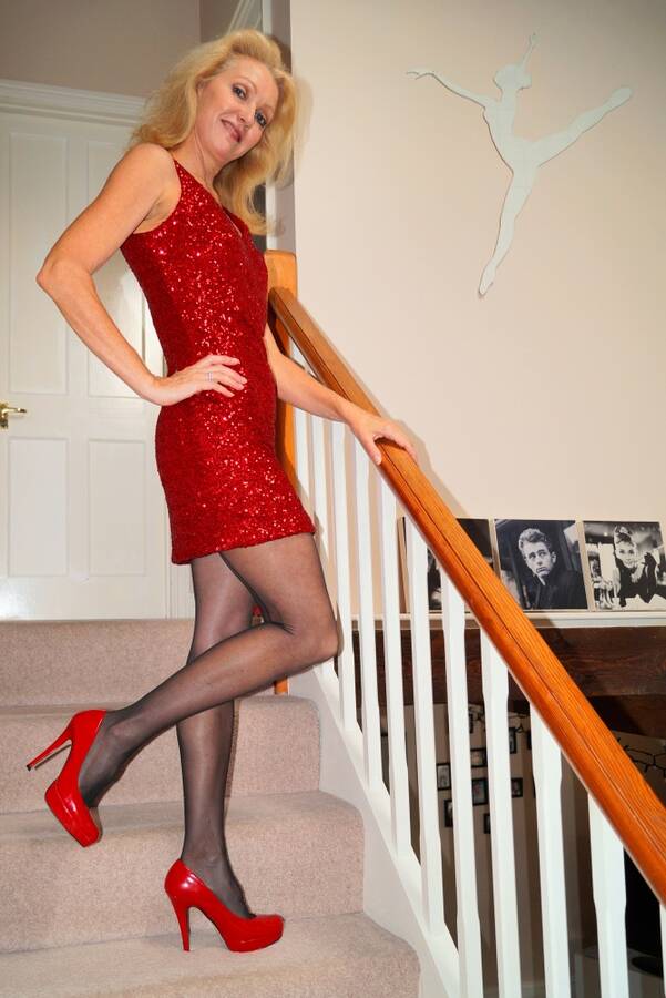 photographer Alan Tog glamour modelling photo taken at At models home with @Juliette1961 . glamour shot of the lovely juliette wearing a red sequined dress red shoes and black stockings.