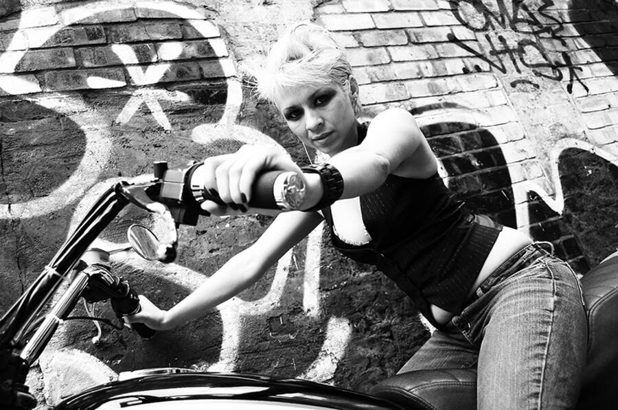 photographer Matchman fashion modelling photo taken at Old Street, London, UK with Coco. coco on the motorbike  looking at camera.